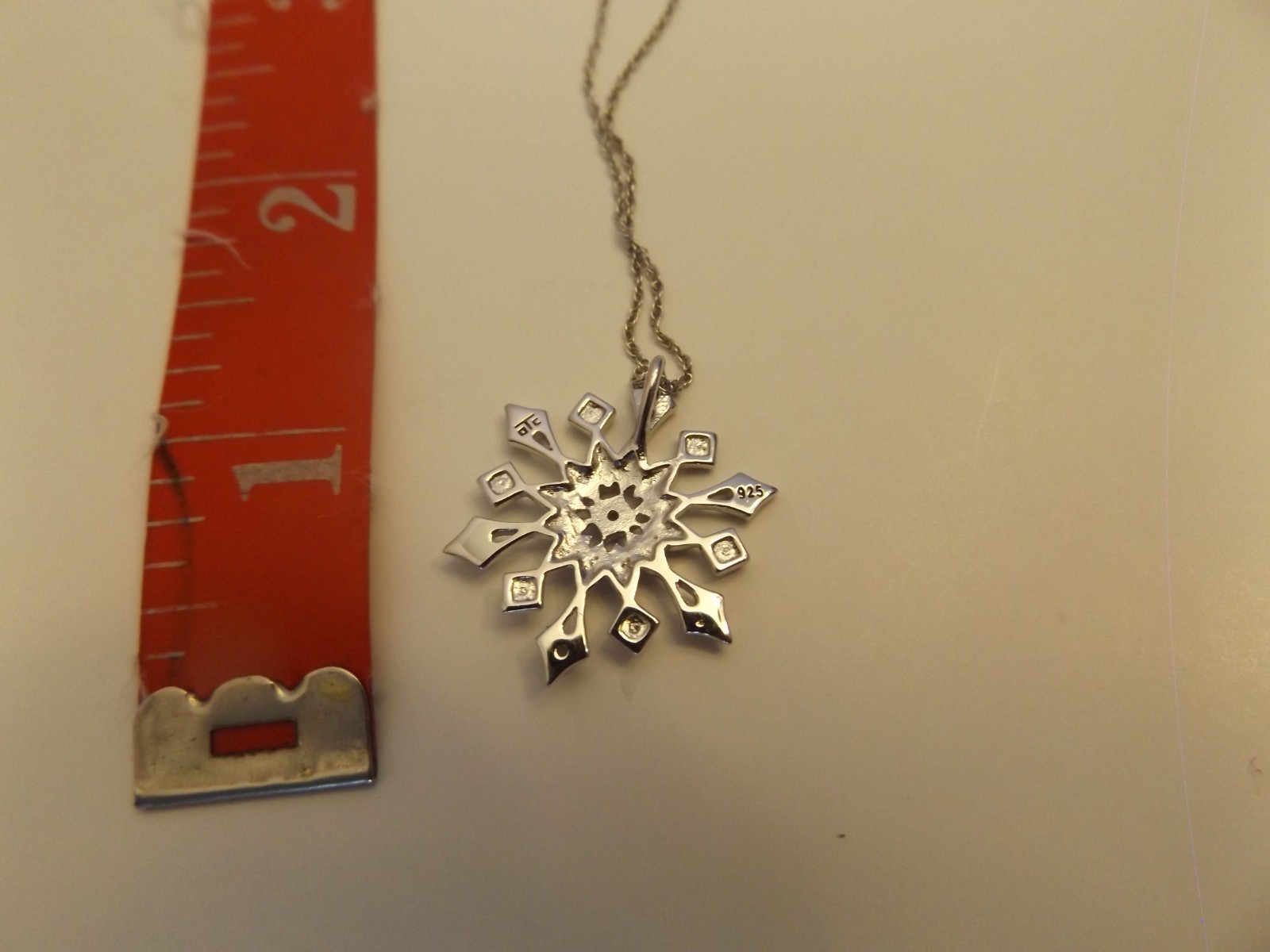 Sterling silver snowflake pendant with diamond accents