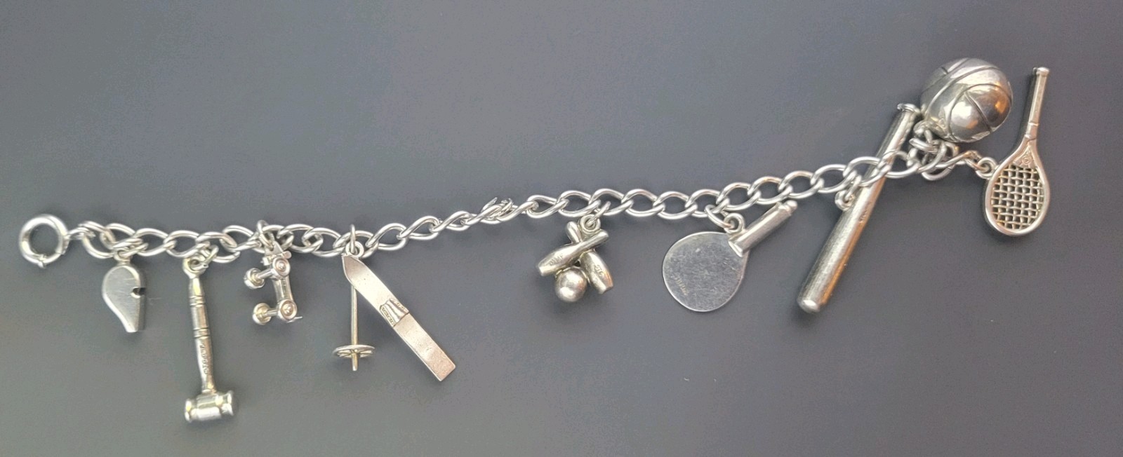 7″ Sterling Silver Sport Bracelet. W/ 9 Charms.
