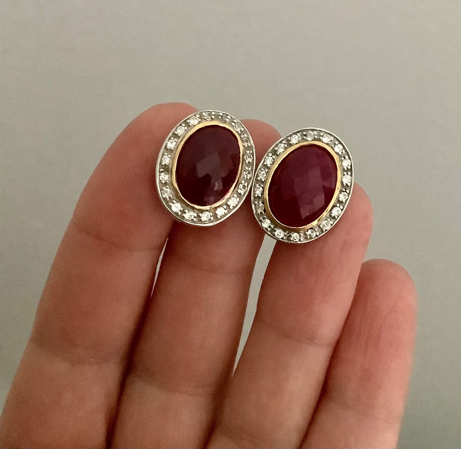 SS/Plat+ 18KV Omega Back Oval Opaque Ruby & White Zircon Halo Stud Earrings